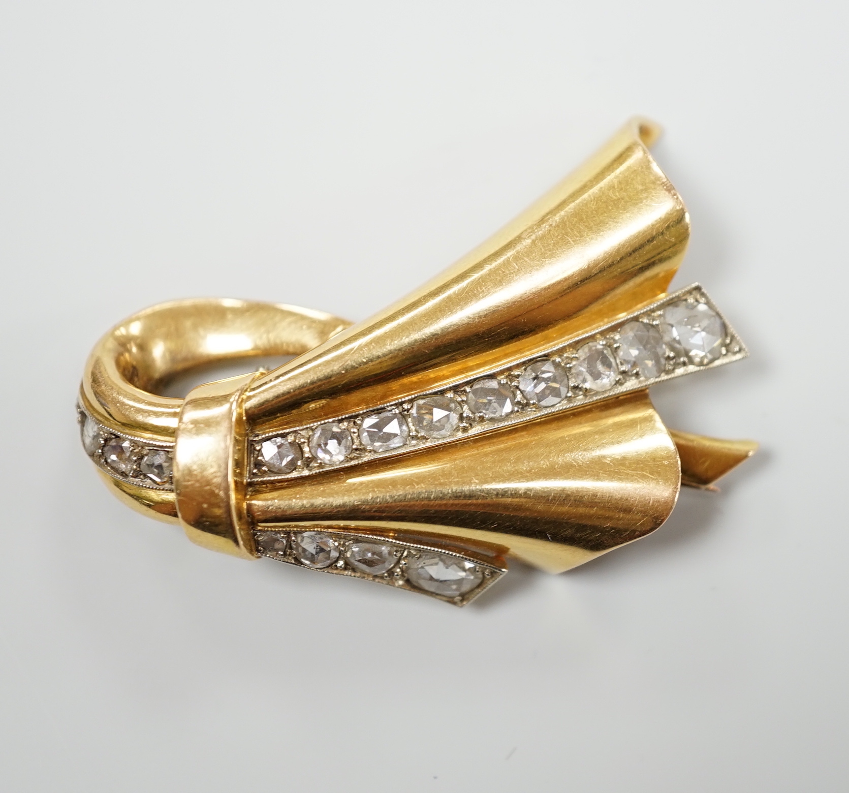 A 1940's/1950's French? yellow metal and graduated rose cut diamond set stylised fan clip brooch, 46mm (one pin missing)